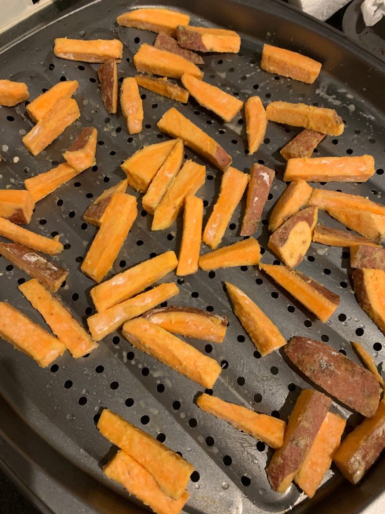 sweet potato fries on a baking tray before being cooked
